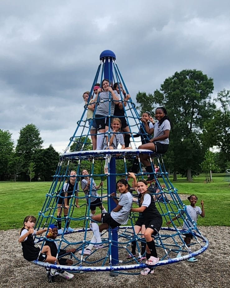 Players on a playground climber after practice